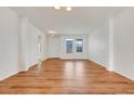 Bright and airy living room with wood flooring, neutral paint and large windows providing ample natural light at 251 Blue Cypress Dr, Groveland, FL 34736