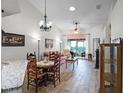 Cozy living room with wood floors, recessed lighting, and sliding glass doors leading to the outside at 26032 Newcombe Cir, Leesburg, FL 34748