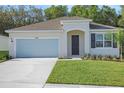 Charming single-story home with well-manicured lawn, attached garage, and inviting front entrance at 2980 Supermarine Rd, Tavares, FL 32778