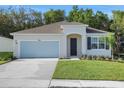 Charming single-story home with well-manicured lawn, attached garage, and inviting front entrance at 2980 Supermarine Rd, Tavares, FL 32778