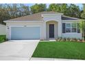 Charming single-story home with well-manicured lawn, attached garage, and inviting front entrance at 2980 Supermarine Rd, Tavares, FL 32778