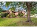 Charming home exterior features lush landscaping and a well-maintained lawn, plus a two-car garage at 3048 New Haven Pl, Mount Dora, FL 32757