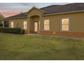 A quaint home exterior features a covered entrance and neatly trimmed shrubs at 3656 Solana Cir # A, Clermont, FL 34711