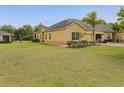 Spacious home exterior features a sprawling green lawn and mature trees at 3656 Solana Cir # A, Clermont, FL 34711