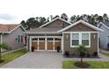 Charming home featuring a brick-paved driveway, a two-car garage and tidy landscaping at 368 Alcove Dr, Groveland, FL 34736