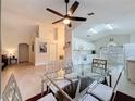 Open dining area with a glass table, modern chairs, tile floors, and lots of natural light at 3684 Eversholt St, Clermont, FL 34711