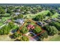 Aerial shot of a home with lush landscaping and a golf course view, highlighting the property's location and curb appeal at 39023 Griffin Lndg, Lady Lake, FL 32159