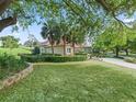 Expansive yard featuring mature trees, shrubs, and well-maintained lawn with a view of the side exterior at 39023 Griffin Lndg, Lady Lake, FL 32159