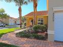 Landscaped front yard with a brick walkway leading to the townhome's entrance at 5375 Compass Pt # 04, Oxford, FL 34484