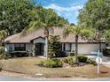 Charming single-story home featuring meticulously landscaped front yard and a two-car garage at 5906 Prince Philip Ct, Leesburg, FL 34748