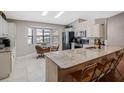 Bright kitchen with granite counters, stainless appliances, tile floor and a cozy breakfast nook at 5906 Prince Philip Ct, Leesburg, FL 34748