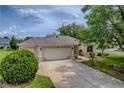 Well-maintained single-story home with a three-car garage and inviting curb appeal at 725 Beldon Ct, The Villages, FL 32162