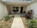Charming front porch with seating area and beautiful landscaping at 725 Beldon Ct, The Villages, FL 32162