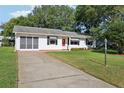 Well-maintained home with a long driveway, screened porch, and manicured lawn at 915 Sutherland Ct, Leesburg, FL 34788