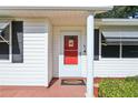 Close-up of a charming front door with sidelights and a 'Welcome' mat at 915 Sutherland Ct, Leesburg, FL 34788