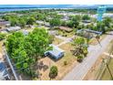An aerial view of single-story house in a neighborhood, with tree-lined streets and mature trees at 1109 Hampton St, Clermont, FL 34711