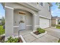 Inviting home exterior with a white front door, neutral siding, and manicured landscaping creating an attractive curb appeal at 113 Camilla Rd, Deland, FL 32724