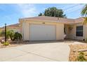 Shot of the two-car garage and front walkway of the home at 1208 Santa Cruz Dr, The Villages, FL 32162