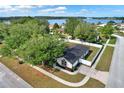Aerial view of property showing a fenced-in yard near a beautiful lake with lush trees, providing a sense of privacy at 1313 Lake Idamere Blvd, Tavares, FL 32778