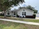 Charming one-story home featuring well-maintained landscaping and a welcoming entrance at 1313 Lake Idamere Blvd, Tavares, FL 32778
