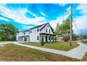 Lovely two-story home boasting a manicured lawn, inviting front porch, and neutral color scheme at 1336 Crystal Lake E Ave, Orlando, FL 32806