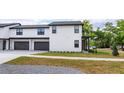 Modern townhome exterior featuring a two-car garage and sleek design with black trim at 1336 Crystal Lake E Ave, Orlando, FL 32806
