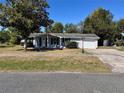 Charming single-story home featuring a covered entrance, attached garage, and a well-maintained lawn at 14346 Sw 39Th Ter, Ocala, FL 34473