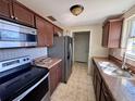 Functional kitchen with wood cabinets, and modern appliances, offering ample storage and food preparation space at 14346 Sw 39Th Ter, Ocala, FL 34473
