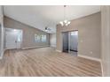 Bright, open living area featuring vaulted ceilings and modern wood-look flooring at 1566 Lawndale Cir, Winter Park, FL 32792