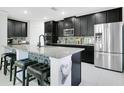 This kitchen features granite counters, stainless steel appliances and dark cabinets with a tiled backsplash at 161 Williamson Dr, Davenport, FL 33897