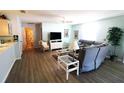 Bright living room featuring wood floors, ceiling fan and a comfortable seating area at 1650 Duran Dr, The Villages, FL 32162