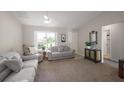 Bright living room featuring comfortable seating and neutral decor at 1733 Oakville Pl, The Villages, FL 32162