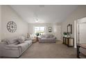 Comfortable living room featuring a ceiling fan and neutral-toned furniture at 1733 Oakville Pl, The Villages, FL 32162