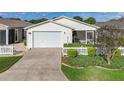 Cozy single-story home with a two-car garage, cute picket fence, and manicured landscaping at 17428 Se 82Nd Albemarle Ave, The Villages, FL 32162