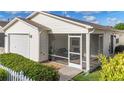 Enclosed screened patio with comfortable seating, offering a relaxing outdoor living space at 17428 Se 82Nd Albemarle Ave, The Villages, FL 32162