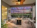 Relaxing screened-in lanai with fire pit and golf course view at 17769 Se 121St Terrace Rd, Summerfield, FL 34491