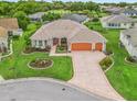 Charming single-story home with a three-car garage, manicured lawn, and colorful landscaping at 1804 Estafana Way, The Villages, FL 32159