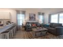 Inviting living room with modern furnishings, stylish decor, and lots of natural light at 1914 Hux Ct, The Villages, FL 34762