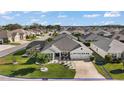 Suburban home boasts meticulous landscaping, screened pool, and tranquil neighborhood setting at 1940 Dempsey Ln, The Villages, FL 32163