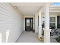 Charming front porch with decorative pillars and a cozy ambiance at 1940 Dempsey Ln, The Villages, FL 32163