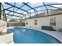 Inviting screened-in pool area with comfortable seating, perfect for relaxation and entertaining at 1940 Dempsey Ln, The Villages, FL 32163