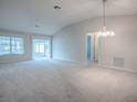 Open concept living room featuring high ceilings, ceiling fan, and sunroom access for ample natural light at 2103 Patino Ln, The Villages, FL 32159