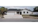 Well-kept single-story home with attached garage and inviting front yard, great curb appeal at 2600 Pisces Dr, Orlando, FL 32837