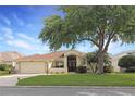 Inviting home with a well-kept lawn, complemented by mature landscaping and an arched entryway at 27024 Old English Ct, Leesburg, FL 34748