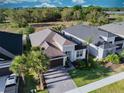 An aerial view showcasing the property's layout, landscaped yard, and neighborhood surroundings at 2749 Hilltop Rd, Clermont, FL 34711