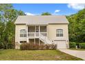 Charming two-story home with a screened porch, white railings, and a one-car garage at 2870 Belinda Dr, Deland, FL 32720