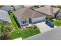 Aerial view of the home showing landscaping, driveway, and proximity to neighboring houses at 2992 Hicks Pl, The Villages, FL 32163