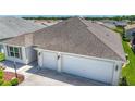 Aerial view of home featuring a spacious two-car garage and a driveway at 2992 Hicks Pl, The Villages, FL 32163
