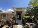 Charming front entrance featuring a decorative door, manicured shrubs, and a well-lit walkway at 3030 Brighton Rd, Eustis, FL 32726