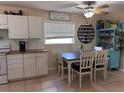 Cozy dining area with white cabinets and seating for four by a window at 312 North Blvd W, Davenport, FL 33837